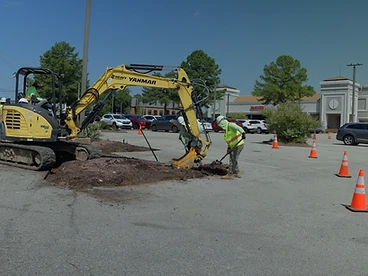 901 Lawnscape crew operating an excavator on a commercial site