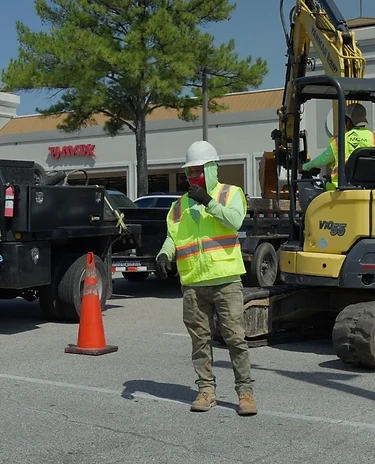 Commercial landscape crew installing plants and hardscaping at a business property in Memphis, TN