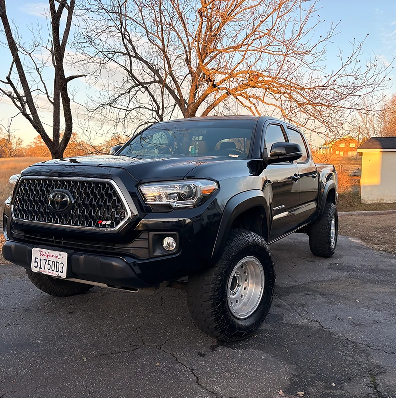 Freshly detailed black Toyota Tacoma pickup truck at golden hour