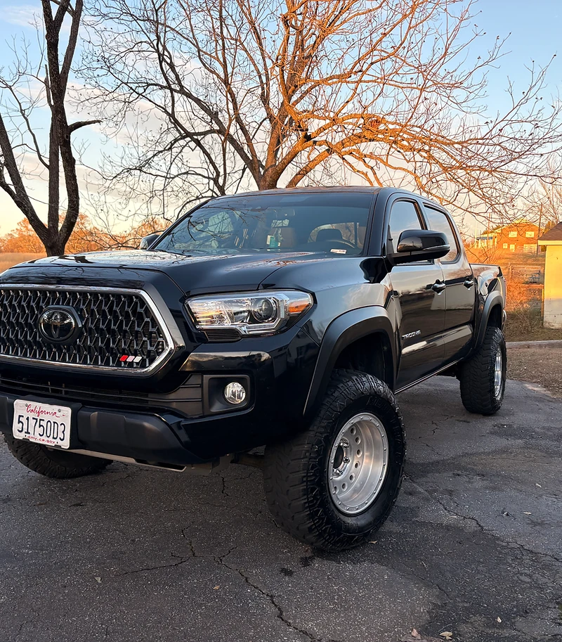 Freshly detailed black Toyota Tacoma pickup truck at golden hour