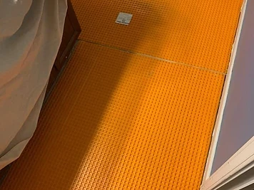 Schluter Ditra uncoupling membrane installed in a bathroom before tile flooring