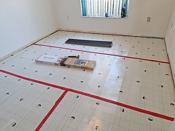 Floor preparation with the subfloor being cleaned and leveled before flooring installation