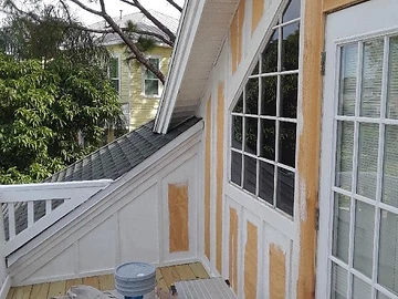Exterior renovation showing siding and trim work on a home exterior