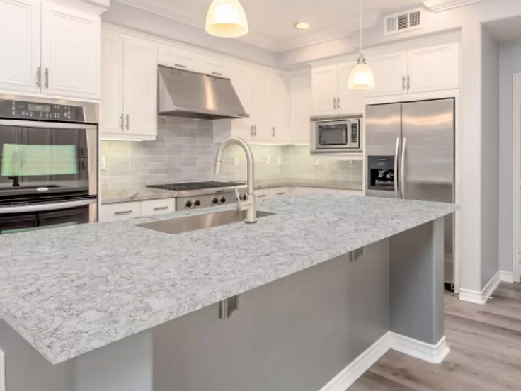 Gray stone countertop with a waterfall edge on a kitchen island