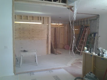 Interior framing during a home addition by Home Res-Q showing wall studs and structural openings