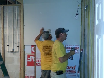 Drywall panels being installed during an interior renovation by Home Res-Q