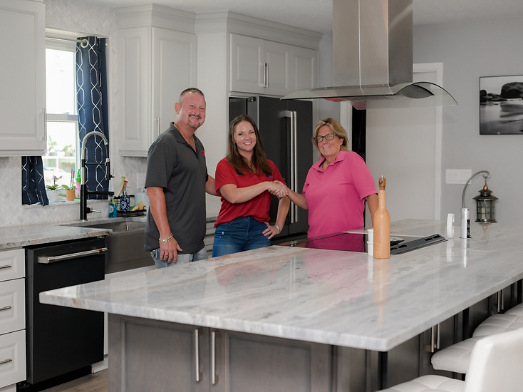 Home Res-Q team with a homeowner in her completed kitchen remodel