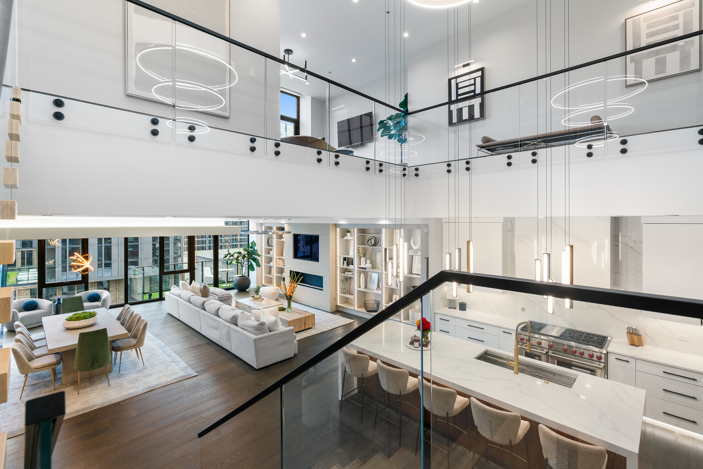 The double-height great room at 111 S Peoria Street PH03, seen from the upper landing