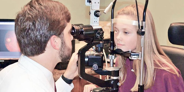 Optometrist giving an eye exam in a modern clinic