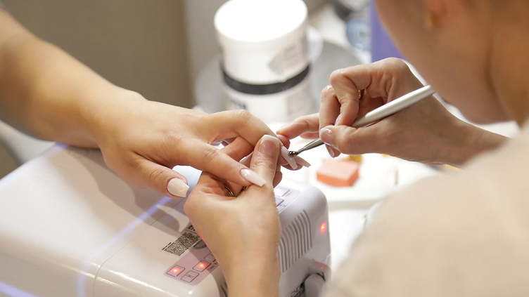 Nail Salon checking new job requests on his phone