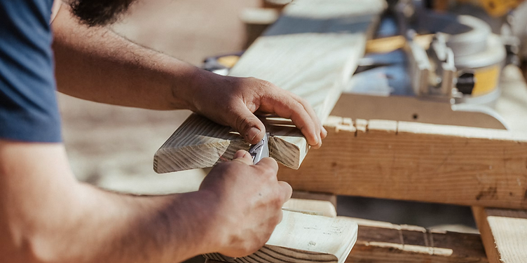 Handyman measuring wood for a job