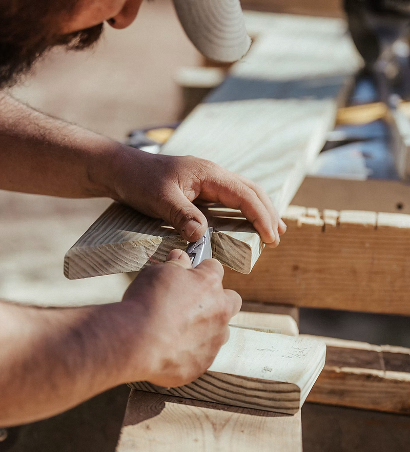 Contractor website design: carpenter cutting wood on a job site