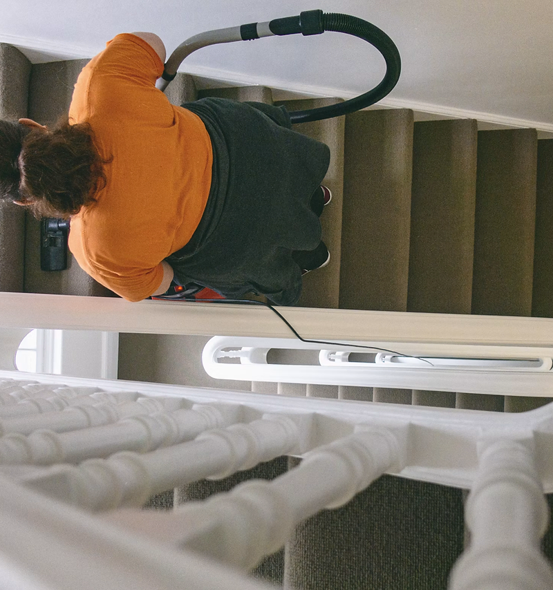 Carpet cleaning website design: technician cleaning a living room carpet