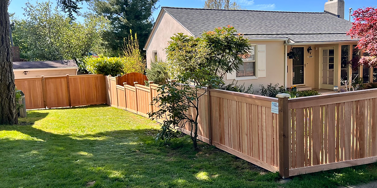 Fence installer building a wooden privacy fence
