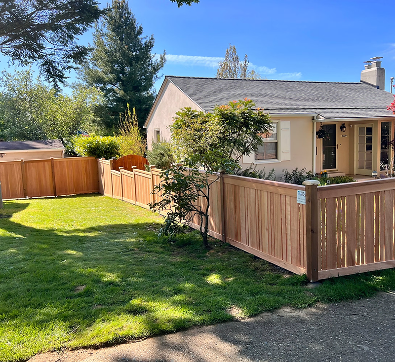 Fence installer building a wooden privacy fence