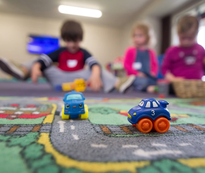 Toddlers playing with blocks in a daycare classroom
