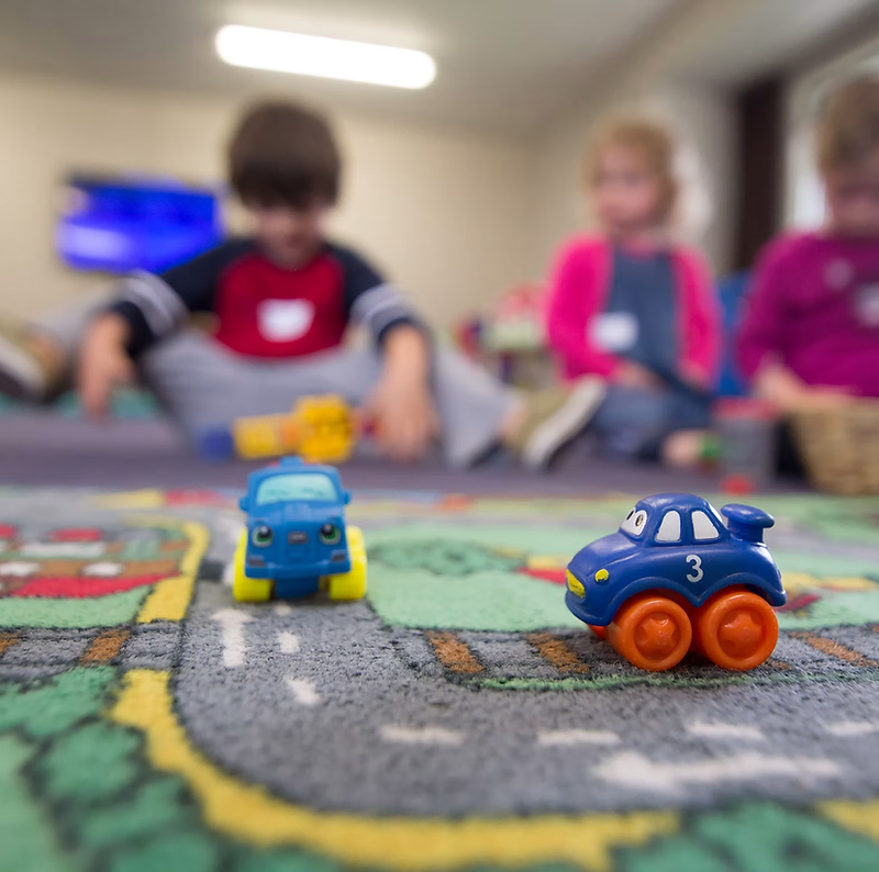 Daycare website design: children playing in a bright classroom