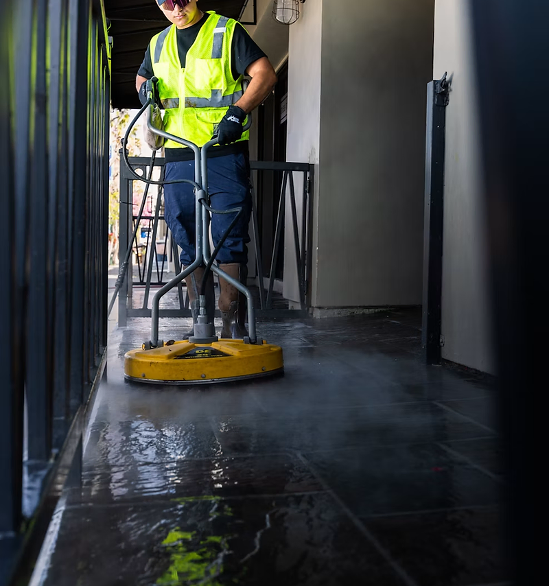 Cleaning company website design: cleaner washing a tiled walkway