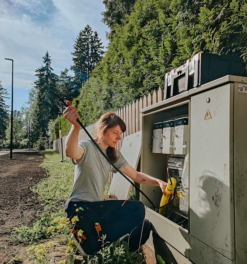 Electrician website design: electrician testing a residential panel