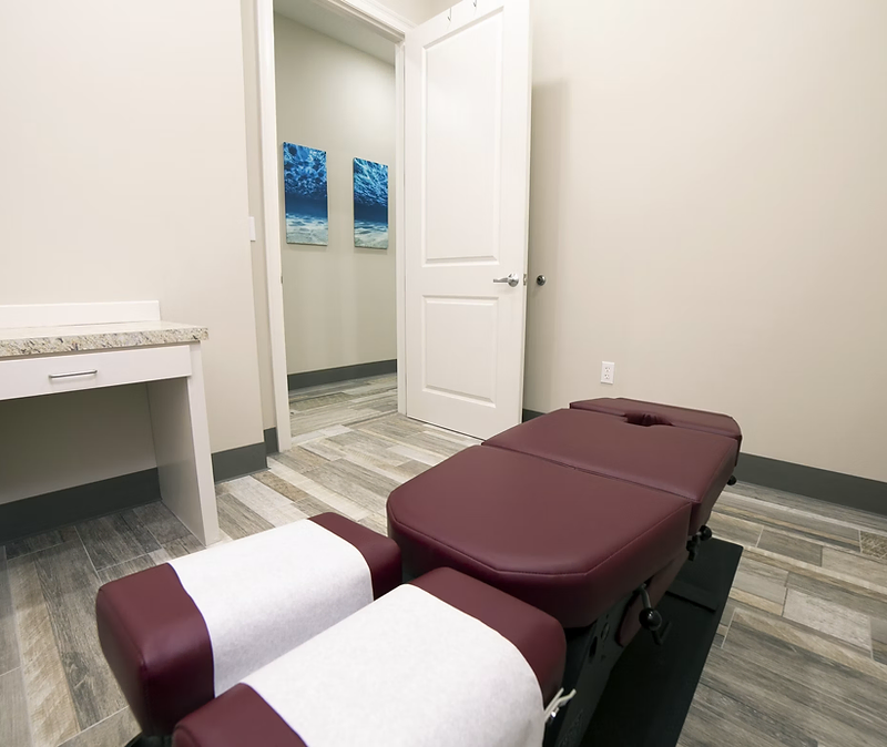 Chiropractic adjustment table in a clean treatment room