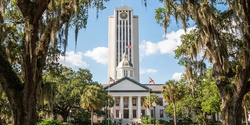 Tallahassee capitol buildings framed by live oaks and Spanish moss