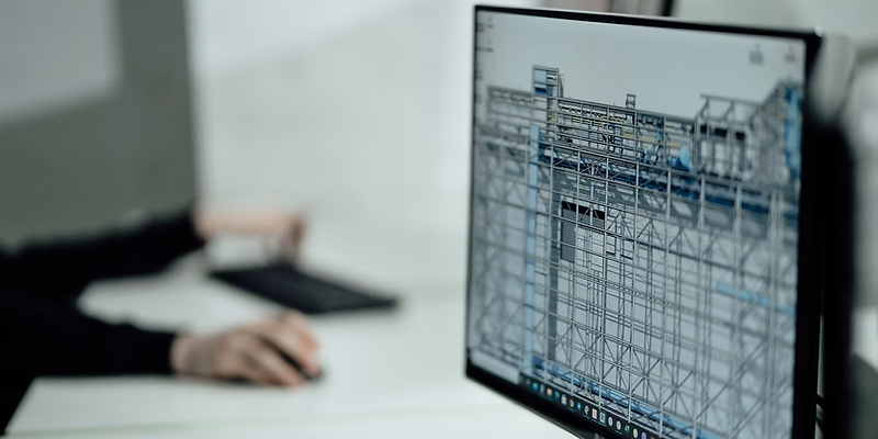 Architect working on a 3D building model on a computer screen