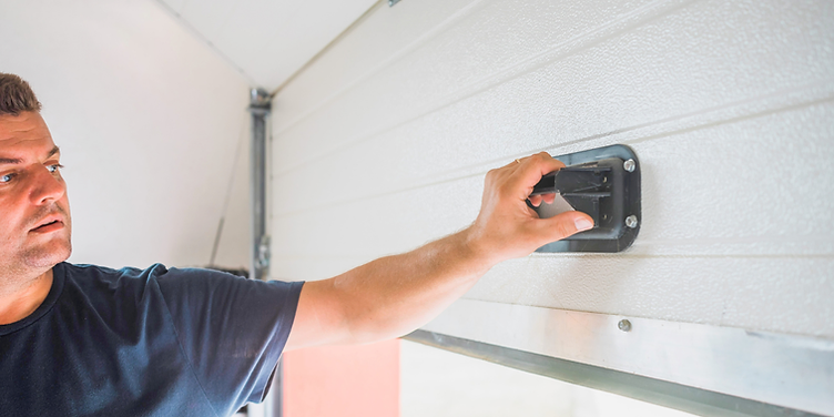 Technician installing a residential garage door