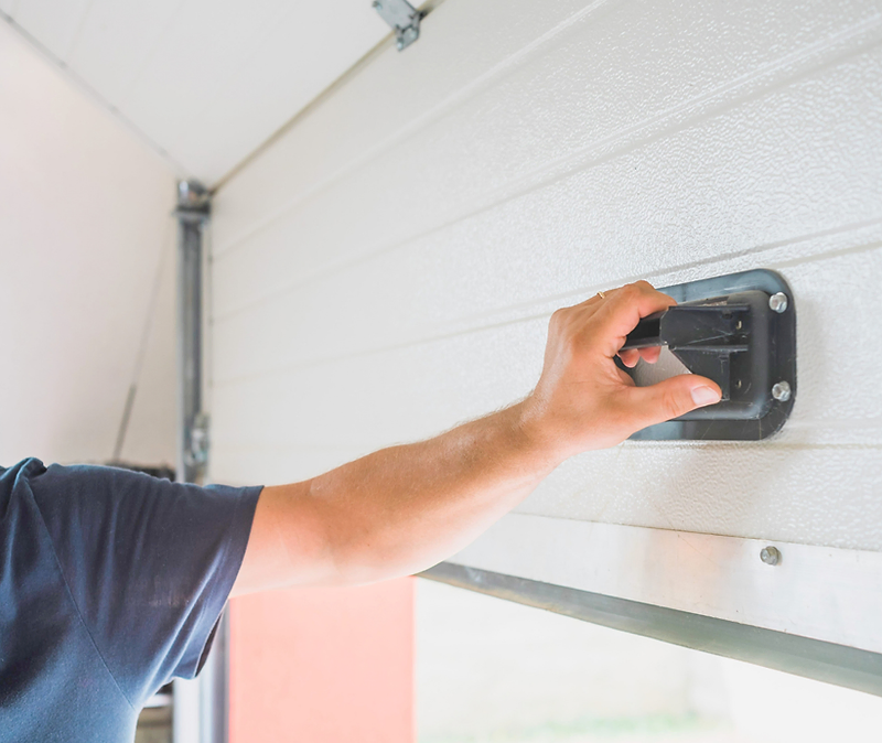 Technician installing a residential garage door
