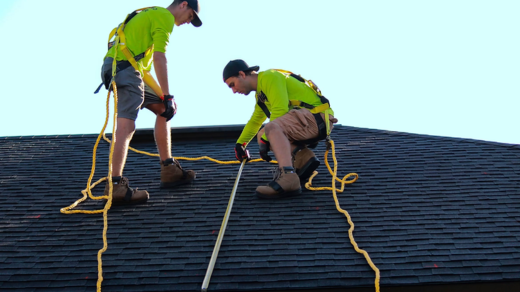 Roofing Company checking new job requests on his phone