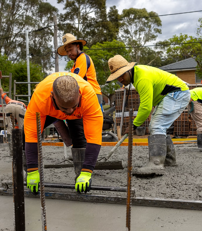 Concrete contractor website design: crew finishing a new driveway