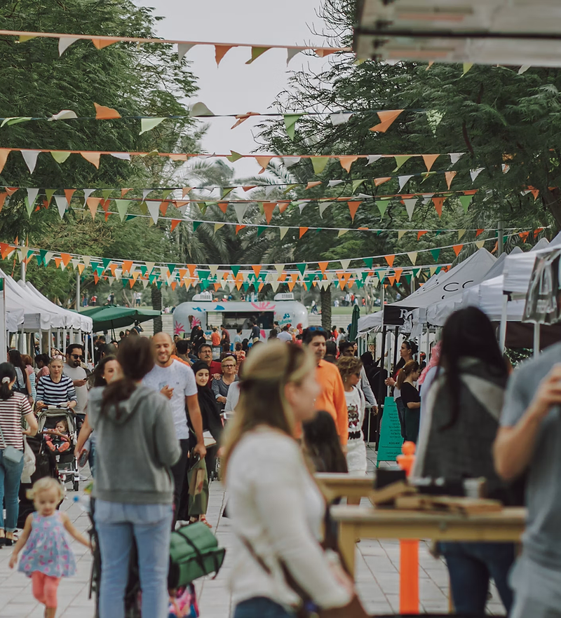 Event planner website design: busy outdoor festival with tents and bunting