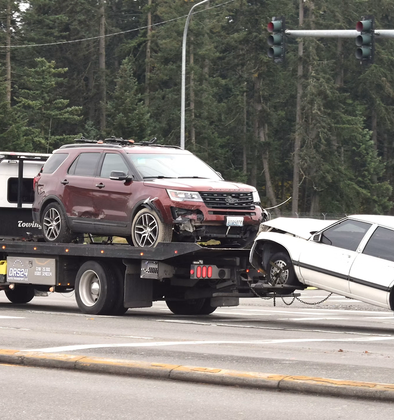 Towing company website design: tow truck loading a car onto a flatbed