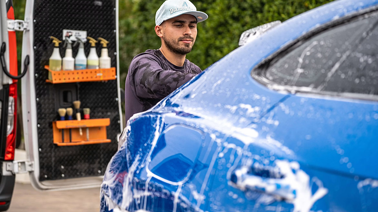 Auto Detailing checking new job requests on his phone