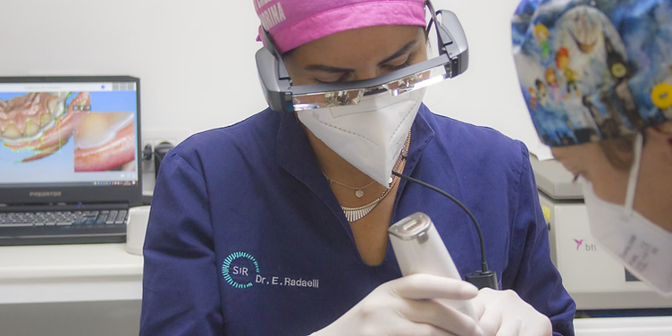 Orthodontist scanning a patient's teeth with an intraoral scanner