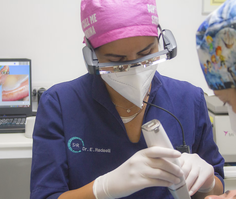 Orthodontist scanning a patient's teeth with an intraoral scanner