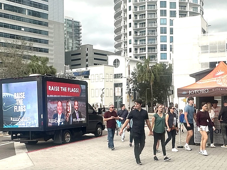 BeSeen mobile LED billboard truck featuring Reed & Reed advertising parked on a city street in Tampa