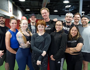 The FreeStar coaching team together on the gym floor