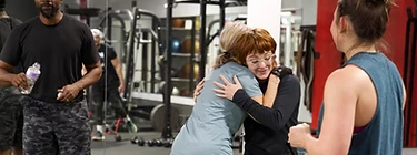 Two FreeStar members hugging after a class