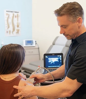 Dr. Roberts, DC performing diagnostic musculoskeletal ultrasound