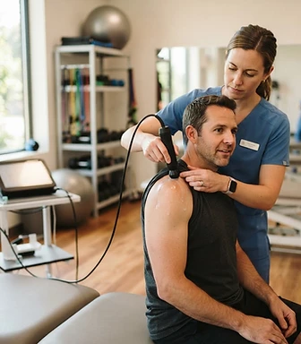 Dr. Roberts, DC treating a patient with focused shockwave therapy