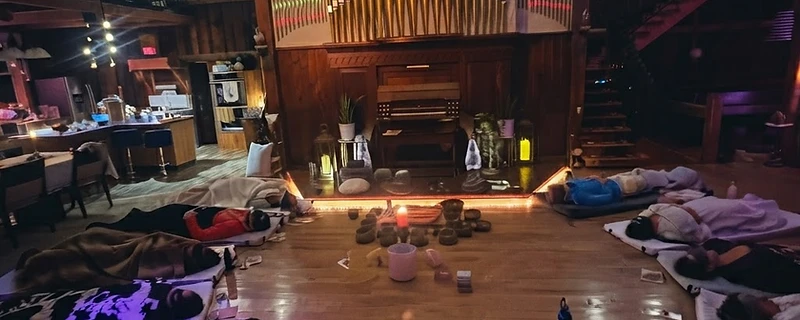 A singing bowl resting on dark timber