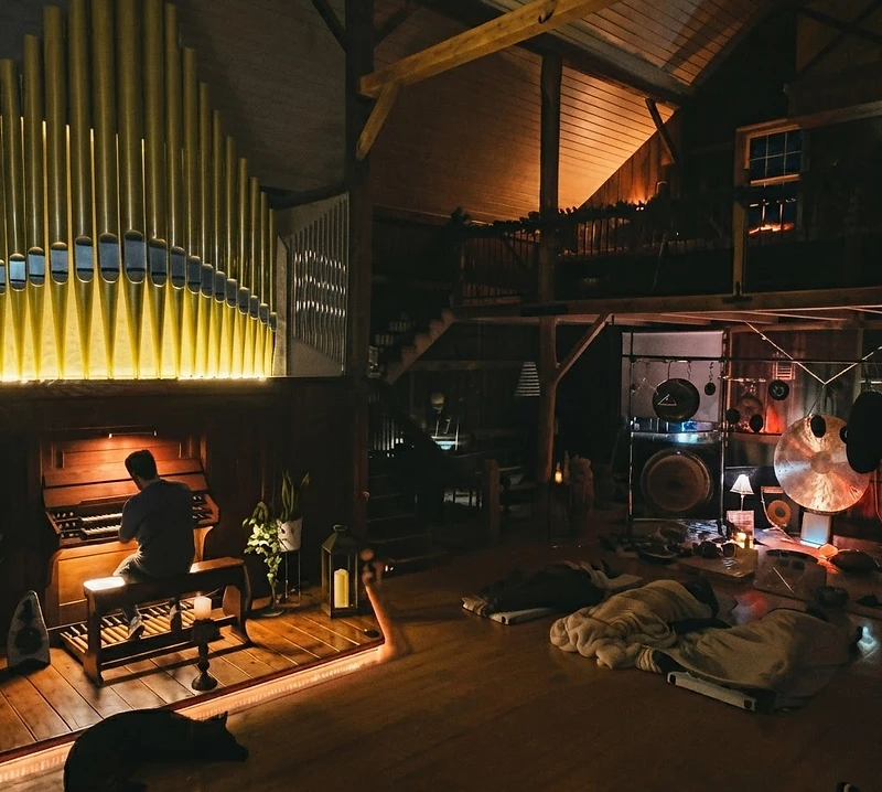 A gong bathed in candlelight beneath the cosmos