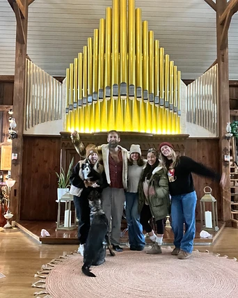 A group gathered before the pipe organ