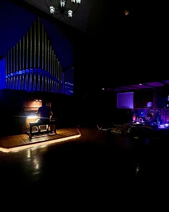 The pipe organ aglow inside The Organ Barn at night