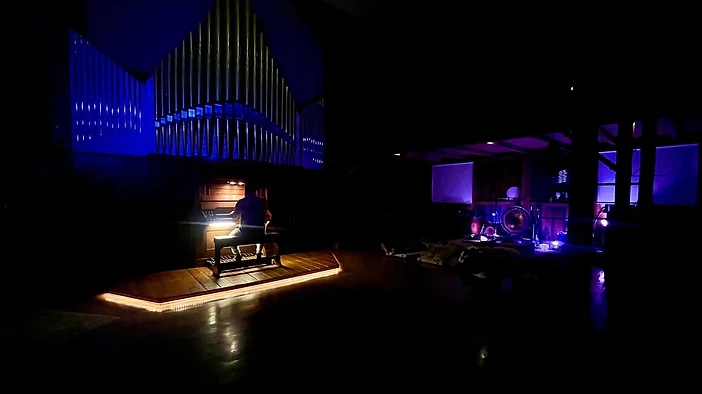 The pipe organ aglow inside The Organ Barn at night