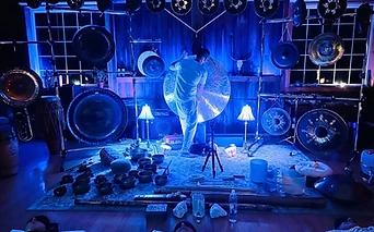 A sound bath altar glowing in deep blue light