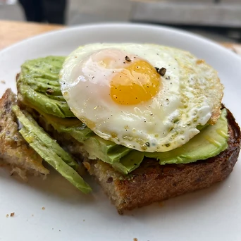 Avocado toast with a fried egg on a plate