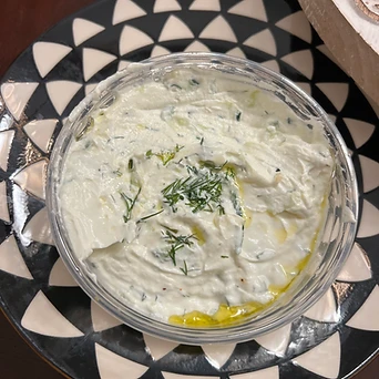 A creamy herb dip garnished with dill and olive oil
