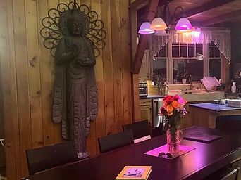 The dining table with roses and a carved Buddha