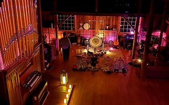 The organ aglow during an evening sound bath